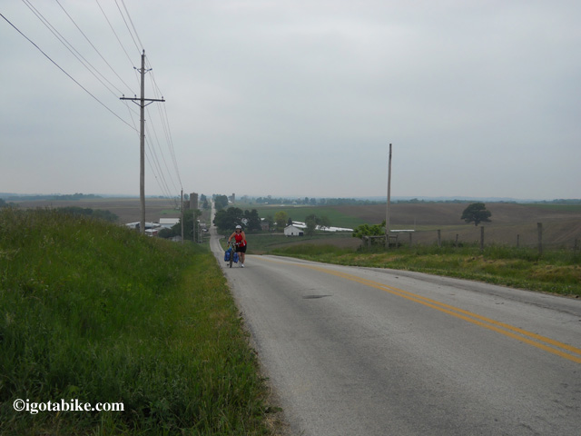 Chris will be riding Route 6 today. This photo shows Carol pushing her loaded Jamis Aurora up on of the more memorable hills in May 2012.