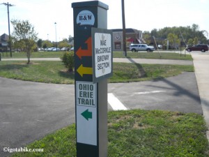 When we rode through Columbus in August 2012 we saw many new posts that “appear” to be marking the turns in the trail. They are green, metal, 4 x 4 posts, about chest high. This one included stickers for the Ohio to Erie trail but all others were blank. 